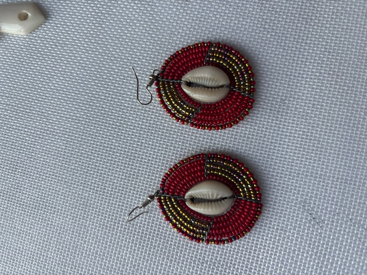 Maasai Beaded Cowrie Hoop Earrings — red and gold with cowrie shell