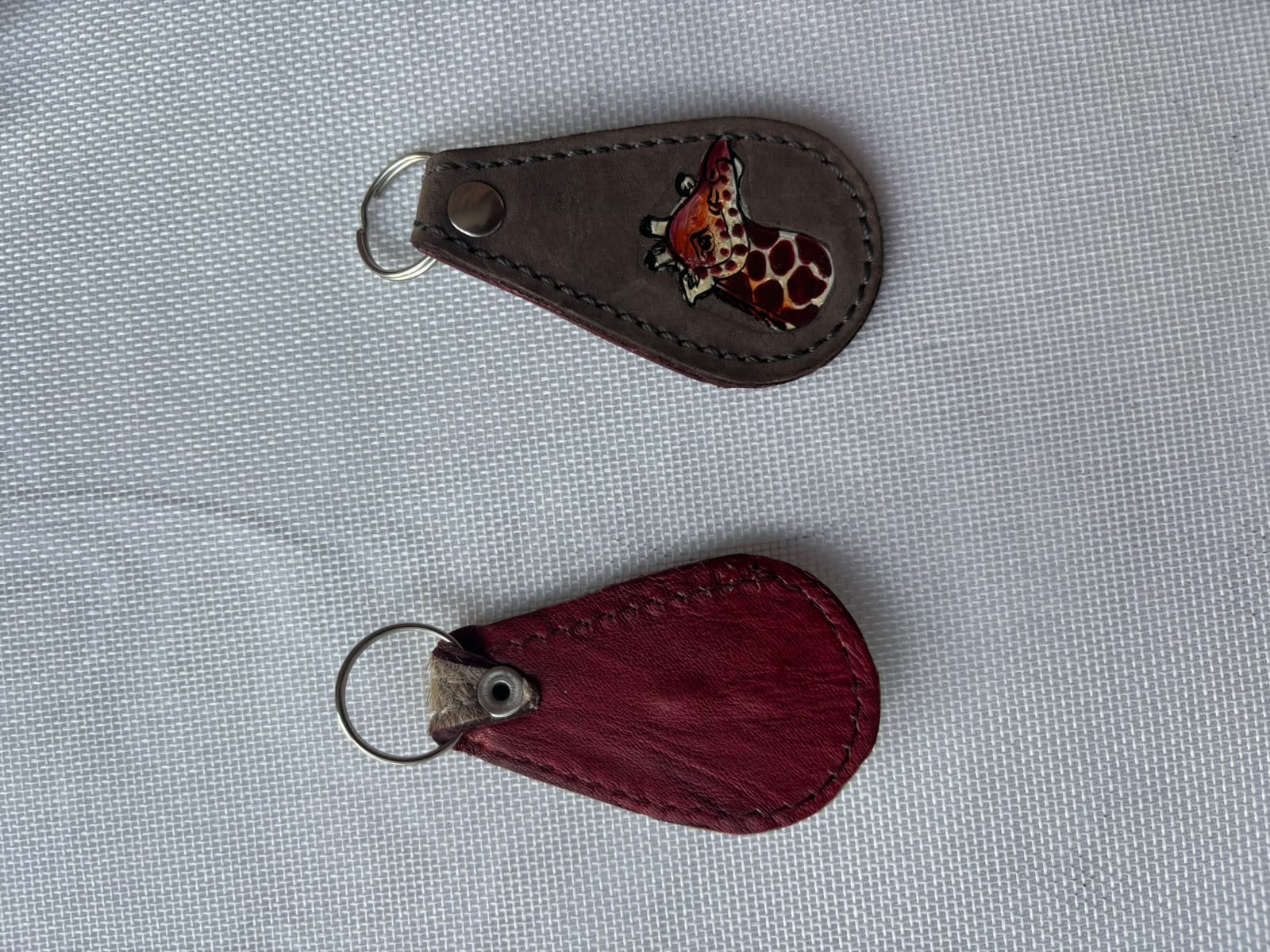 Buffalo Soldier Keychain — dark leather with giraffe emblem and plain red