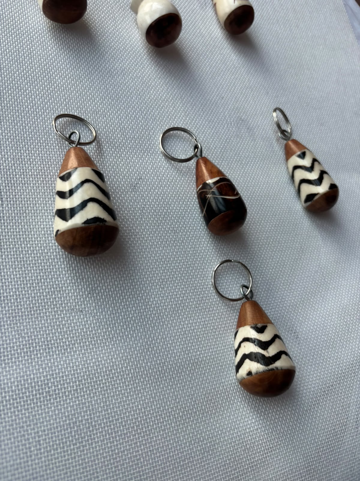 Calabash Carved Keychain — multiple chevron stripe designs laid out