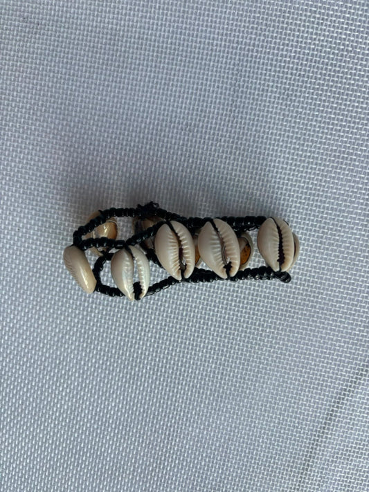 Cowrie shell bracelet on black woven cord