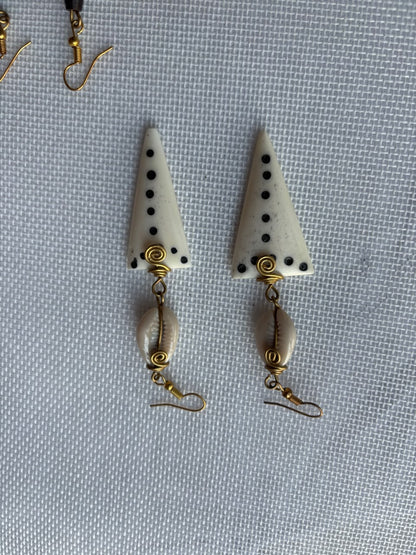 Ivory Triangle Bone Drop Earrings — black dots, gold spiral and cowrie shell dangle