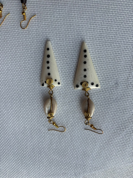 Ivory Triangle Bone Drop Earrings — black dots, gold spiral and cowrie shell dangle