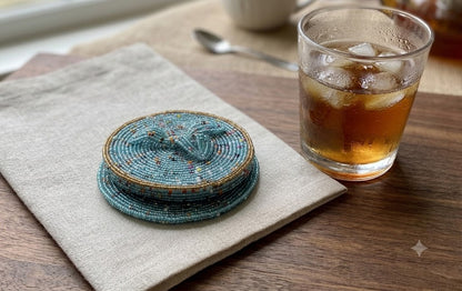 Stack of blue beaded coasters next to iced drink