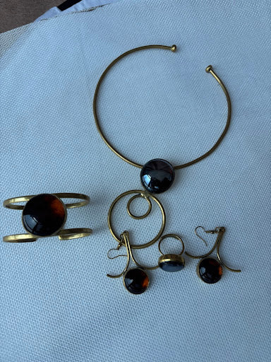 Royal Amber Set flat lay — choker necklace, cuff bracelet, ring and earrings in brass and amber fused glass