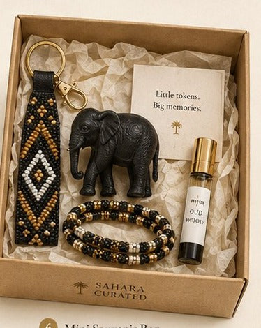 SAHARA Mini Souvenir Box — beaded keychain, elephant figurine, bracelet, and Oud Wood mini perfume