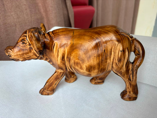 Hand-carved wooden buffalo sculpture side view