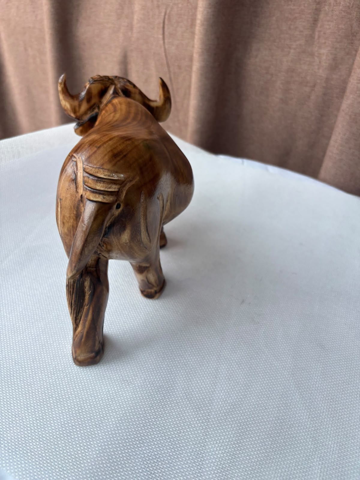 Hand-carved wooden buffalo sculpture rear view