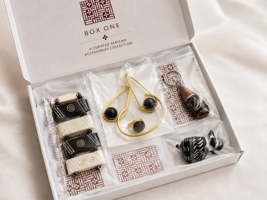 Curated African accessories gift set with carved bone bracelet, jewelry, keychain and rhino figurine