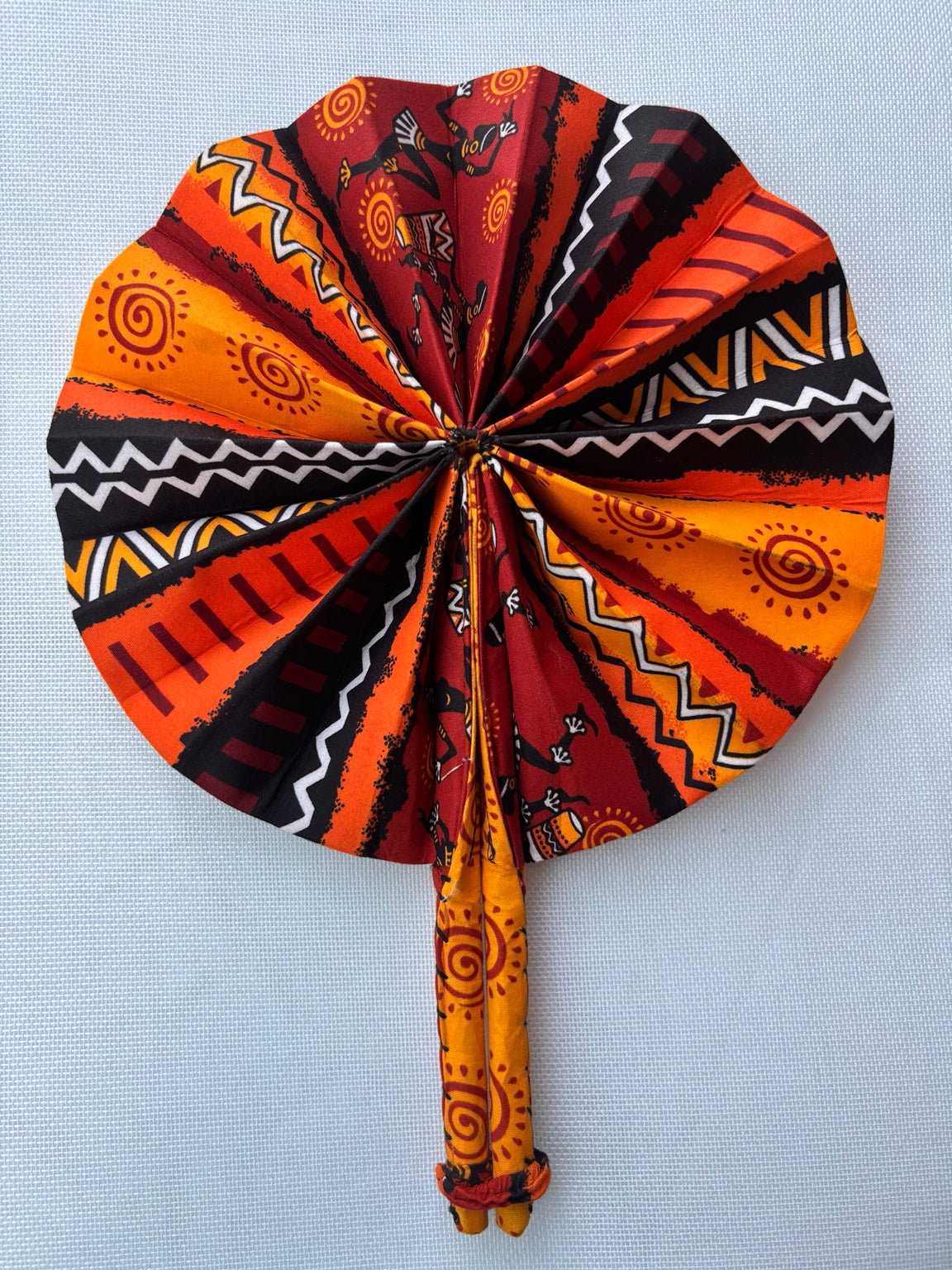 Orange dashiki print folding fan
