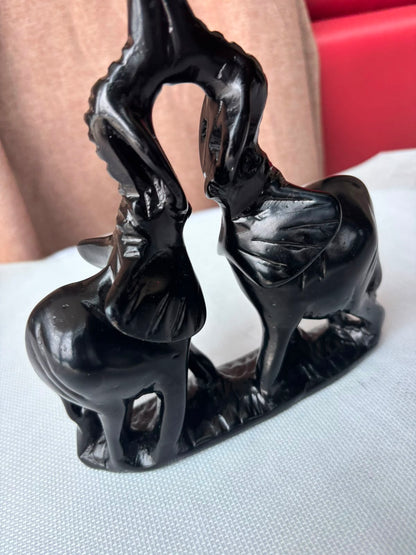 Black elephant pair sculpture angled view