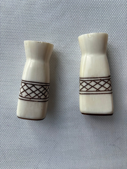 Carved ivory-tone salt and pepper set front detail