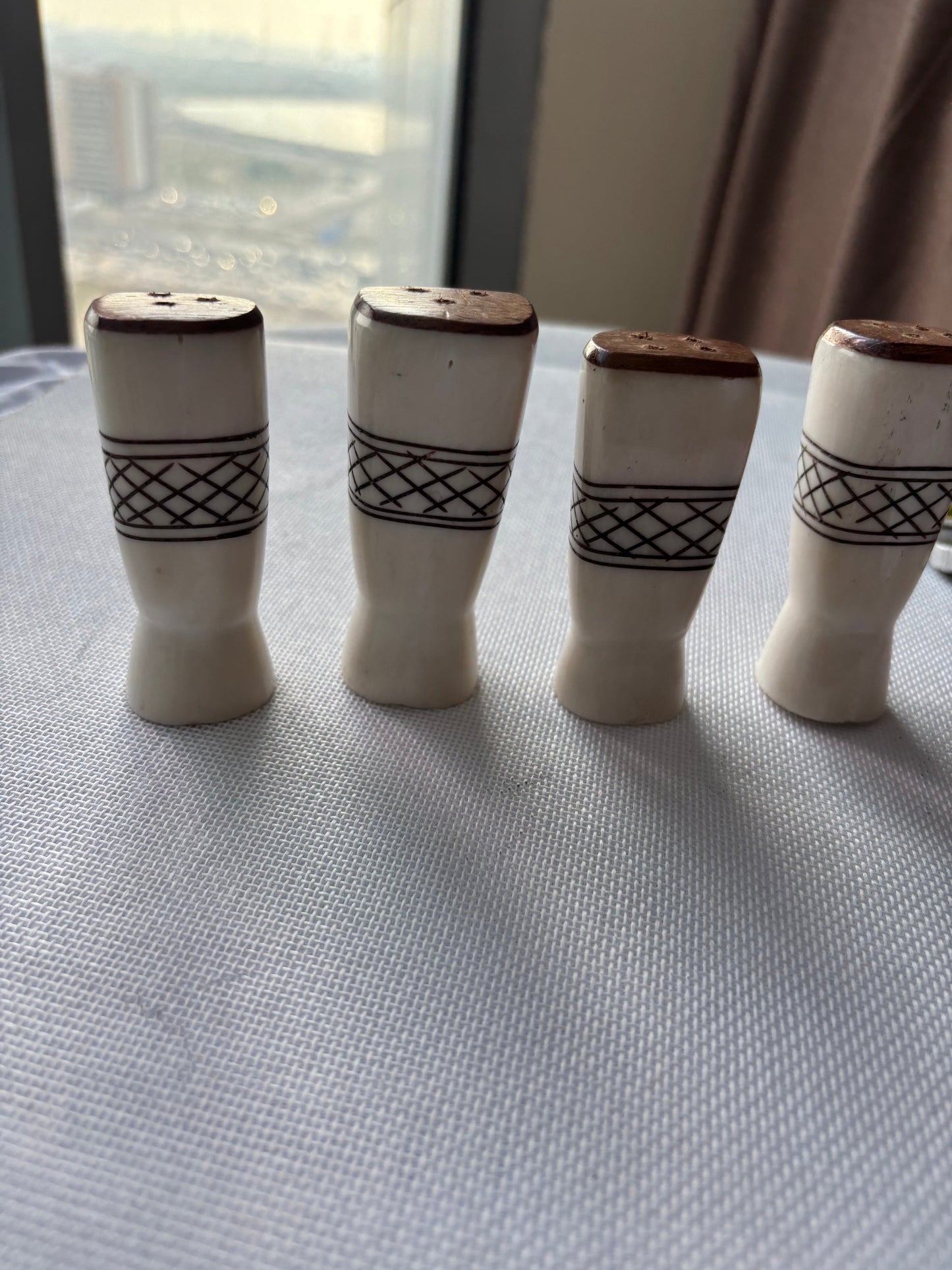 Carved ivory-tone salt and pepper set styled group