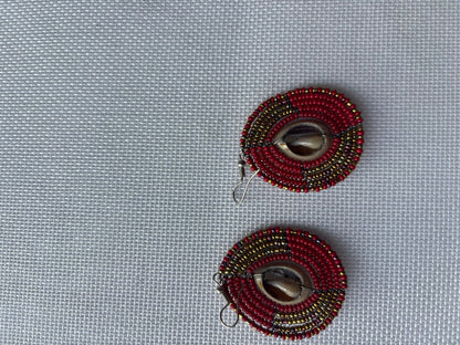 Red and antique-gold beaded statement earrings with cowrie shells