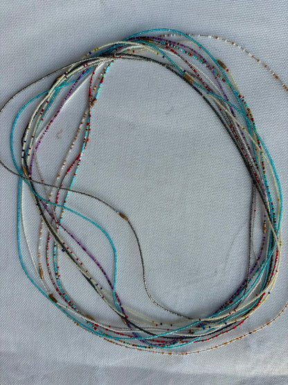 Long assorted waist bead strands in turquoise ivory silver and multicolour