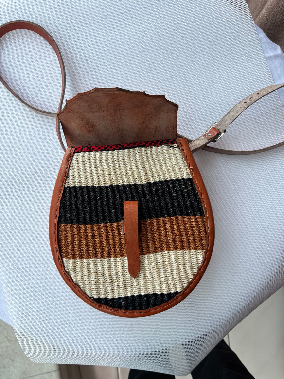 Woven crossbody bag flap detail